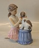 0452 RC Girl dressing a dog a butterfly 17 x 16 cm from the series animal pets (1249452) Royal Copenhagen